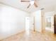 Bright bedroom with tile flooring, ceiling fan, and ensuite bath and closet at 2520 Bella Vista Dr, Davenport, FL 33897