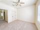 Bedroom featuring neutral carpet, paint, and trim and a ceiling fan and overhead lighting at 2520 Bella Vista Dr, Davenport, FL 33897