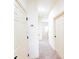 Well-lit hallway with multiple doors and carpeted flooring, creating a clean and functional space at 2520 Bella Vista Dr, Davenport, FL 33897