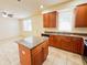 A kitchen with stainless appliances, granite countertops, tile floors, and wood cabinets at 2520 Bella Vista Dr, Davenport, FL 33897