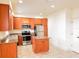 Bright kitchen features tile flooring, stainless steel appliances, granite countertops, and wooden cabinets at 2520 Bella Vista Dr, Davenport, FL 33897