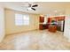 Open-concept living room showcasing tile floors, large windows, and a modern kitchen at 2520 Bella Vista Dr, Davenport, FL 33897