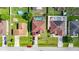 Overhead view of properties featuring fenced yards, swimming pools, lush lawns, and parked cars along the street at 314 Edgewood Ct, Kissimmee, FL 34759