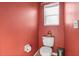 Cozy bathroom featuring a toilet, small window and neutral wall color at 314 Edgewood Ct, Kissimmee, FL 34759