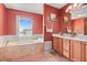 Bathroom features a soaking tub, separate shower, and dual-sink vanity at 314 Edgewood Ct, Kissimmee, FL 34759