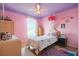 Bright bedroom with a queen bed, ceiling fan, and view of the outdoors at 314 Edgewood Ct, Kissimmee, FL 34759
