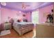 Comfortable bedroom with a large bed, floral bedding, and natural light from the window at 314 Edgewood Ct, Kissimmee, FL 34759