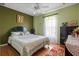 Charming bedroom with a plush bed, natural light, and views of the outdoors at 314 Edgewood Ct, Kissimmee, FL 34759
