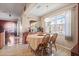 Sunlit breakfast nook features tile floors and multiple windows overlooking manicured landscaping at 314 Edgewood Ct, Kissimmee, FL 34759