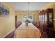 Formal dining room features a large table, elegant decor, and ample natural light, ideal for gatherings at 314 Edgewood Ct, Kissimmee, FL 34759