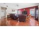 Open-concept living room boasts hardwood floors and comfortable leather seating at 314 Edgewood Ct, Kissimmee, FL 34759
