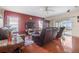 Cozy living room features hardwood floors, leather furniture, and large windows at 314 Edgewood Ct, Kissimmee, FL 34759