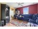 Inviting living room with hardwood floors, blue sofa, and a view of the outdoors at 314 Edgewood Ct, Kissimmee, FL 34759