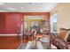 Inviting living room showcasing a unique hanging chair, elegant decor, and hardwood flooring at 314 Edgewood Ct, Kissimmee, FL 34759