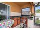 Outdoor kitchen with granite countertops, stainless steel grill, and tile backsplash at 314 Edgewood Ct, Kissimmee, FL 34759
