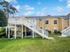 Backyard view with a wooden deck and stairs leading to a well-maintained lawn at 3142 Britannia Blvd # C, Kissimmee, FL 34747