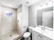 Bright bathroom featuring a walk-in shower, vanity with white cabinets, and a mirrored wall at 3142 Britannia Blvd # C, Kissimmee, FL 34747