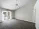 Spacious bedroom with a ceiling fan and access to a private patio at 3142 Britannia Blvd # C, Kissimmee, FL 34747