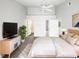 Clean bedroom featuring a ceiling fan, modern furniture, and bright neutral colors at 3142 Britannia Blvd # C, Kissimmee, FL 34747
