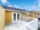 The exterior of the home shows a backyard deck with white wood railing and yellow siding at 3142 Britannia Blvd # C, Kissimmee, FL 34747