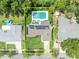 Aerial view of a home with a pristine in-ground pool, solar panels, and manicured landscaping at 320 Bridle Path, Casselberry, FL 32707