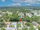 Expansive aerial view of a home with a sparkling swimming pool and lush landscaping in a serene neighborhood at 320 Bridle Path, Casselberry, FL 32707