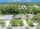 Aerial view of the property featuring a pool, well-manicured lawn, and nearby mature trees at 320 Bridle Path, Casselberry, FL 32707