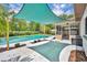 Backyard featuring a shade sail, pool, screened lanai, patio, and mature trees at 320 Bridle Path, Casselberry, FL 32707