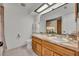 A bathroom featuring double sinks, wood cabinets, and a large mirror at 320 Bridle Path, Casselberry, FL 32707