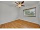 Bedroom with wood flooring, a ceiling fan, and a window with natural light at 320 Bridle Path, Casselberry, FL 32707