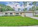 Charming single-story home featuring a well-manicured lawn and a two-car garage at 320 Bridle Path, Casselberry, FL 32707