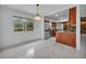 Open dining area with view into kitchen featuring stainless steel appliances and granite countertops at 320 Bridle Path, Casselberry, FL 32707