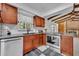 Kitchen featuring wood cabinets, stainless steel appliances, and granite countertops at 320 Bridle Path, Casselberry, FL 32707