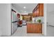 Modern kitchen with stainless steel appliances, granite countertops, and dark wood cabinets at 320 Bridle Path, Casselberry, FL 32707
