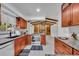 An open kitchen features granite countertops, wood cabinets, and stainless steel appliances at 320 Bridle Path, Casselberry, FL 32707