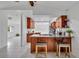 Modern kitchen island featuring granite countertops, bar seating, and wood cabinets at 320 Bridle Path, Casselberry, FL 32707