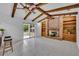 Living room with beamed ceiling, brick fireplace, and sliding glass door to back yard at 320 Bridle Path, Casselberry, FL 32707