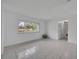 Bright living room featuring tile flooring and a large window overlooking the front yard at 320 Bridle Path, Casselberry, FL 32707