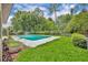 In-ground pool with concrete surround and well-maintained backyard and lawn at 320 Bridle Path, Casselberry, FL 32707