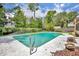 Backyard featuring an in-ground pool with concrete surround and manicured landscaping at 320 Bridle Path, Casselberry, FL 32707