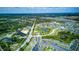 Aerial view of a large community with winding roads, lakes, and a mix of residential and commercial areas at 322 Annabelle Way, Davenport, FL 33837