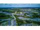 Aerial view capturing a community with ponds, nearby roadways, and commercial areas, illustrating convenient location at 322 Annabelle Way, Davenport, FL 33837