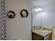 Cozy bathroom featuring a decorative mirror, granite countertop, and honeycomb shelves at 322 Annabelle Way, Davenport, FL 33837