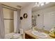 Bathroom features a shower-tub combo with stylish tiling, vanity with granite countertop, and decorative accents at 322 Annabelle Way, Davenport, FL 33837