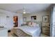 Bright bedroom features patterned wallpaper, a walk-in closet, and a comfortable bed at 322 Annabelle Way, Davenport, FL 33837