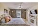 Inviting bedroom with elegant decor, a ceiling fan, and a window that offers a serene view at 322 Annabelle Way, Davenport, FL 33837