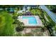 Aerial view of a community pool with an L-shape design, a covered cabana, and plenty of lounge seating at 322 Annabelle Way, Davenport, FL 33837