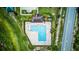 Aerial of L-shaped community pool with a cabana, landscaping, and recreational areas near the road at 322 Annabelle Way, Davenport, FL 33837