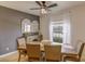 Cozy dining room with a ceiling fan, window, and seating for four at 322 Annabelle Way, Davenport, FL 33837