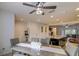 Open-concept kitchen and dining room with stylish light fixture and ample seating at 322 Annabelle Way, Davenport, FL 33837